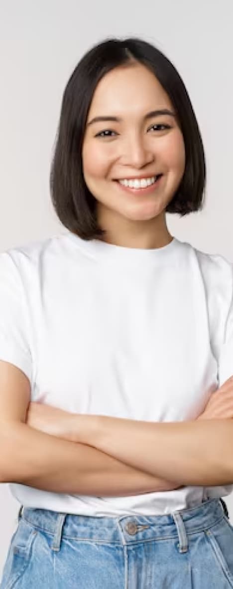 Nicole Santiago in a white t-shirt, arms crossed, smiling